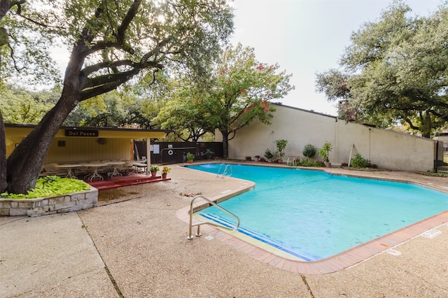 view of pool with a patio area and a wooden deck