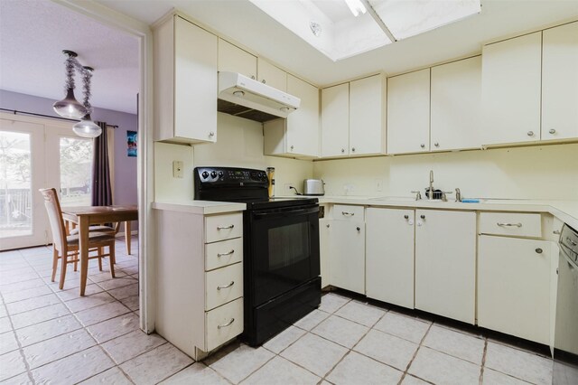 kitchen with white cabinetry, light tile patterned floors, hanging light fixtures, and black range with electric cooktop