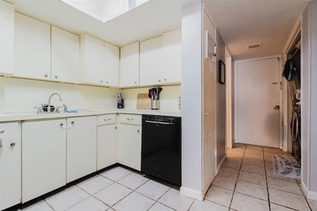 kitchen featuring dishwasher, light tile patterned flooring, white cabinetry, and sink