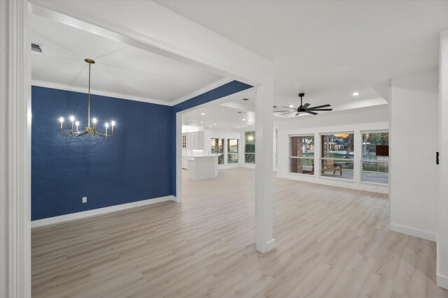 unfurnished living room featuring ornamental molding, ceiling fan with notable chandelier, and light wood-type flooring