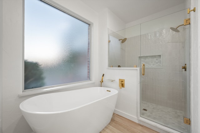 bathroom with hardwood / wood-style floors and plus walk in shower