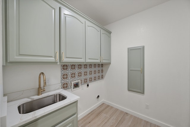 laundry area with sink, cabinets, washer hookup, electric dryer hookup, and light hardwood / wood-style flooring