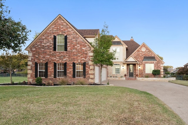 view of front of home featuring a garage and a front lawn