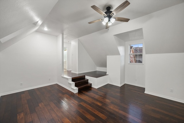 bonus room with dark hardwood / wood-style floors, ceiling fan, lofted ceiling, and a textured ceiling