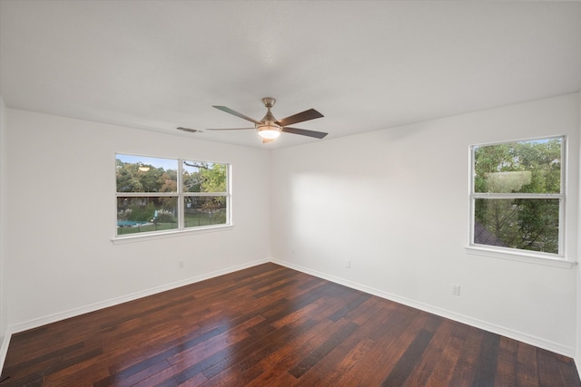 unfurnished room with ceiling fan, dark hardwood / wood-style flooring, and a wealth of natural light