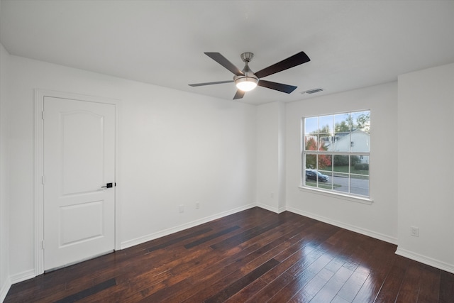 spare room with ceiling fan and dark hardwood / wood-style floors