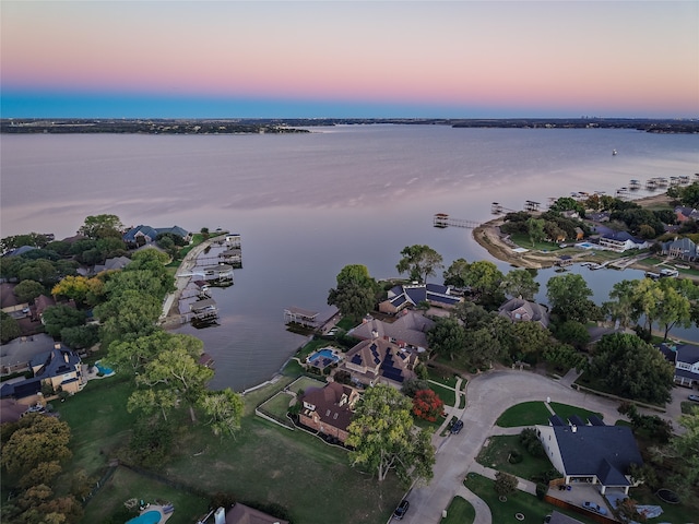 aerial view at dusk with a water view