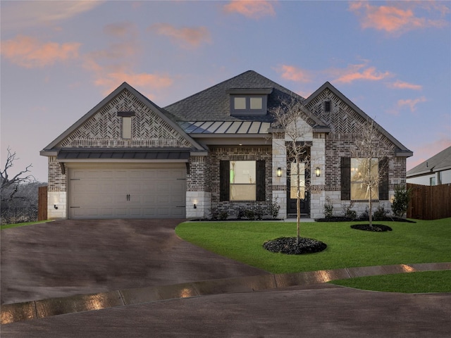 view of front of property with a lawn and a garage