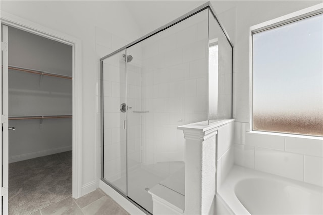 bathroom featuring tile patterned floors and independent shower and bath