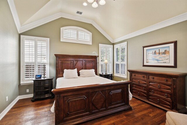 bedroom featuring crown molding, dark hardwood / wood-style flooring, and lofted ceiling