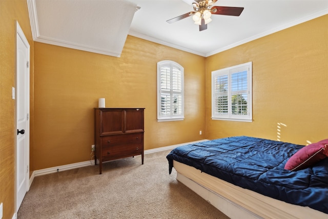 carpeted bedroom with ceiling fan and crown molding