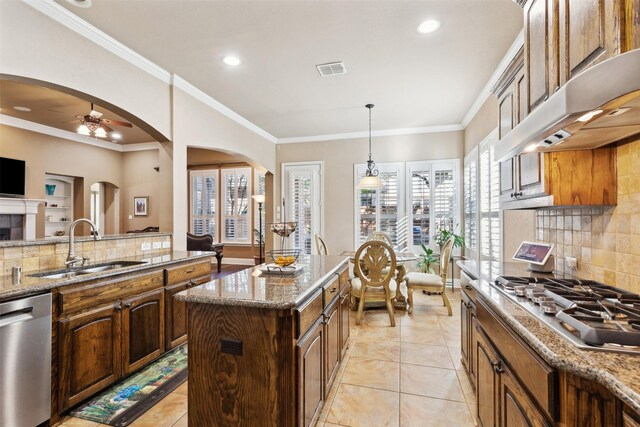 kitchen with tasteful backsplash, sink, a kitchen island, and stainless steel appliances