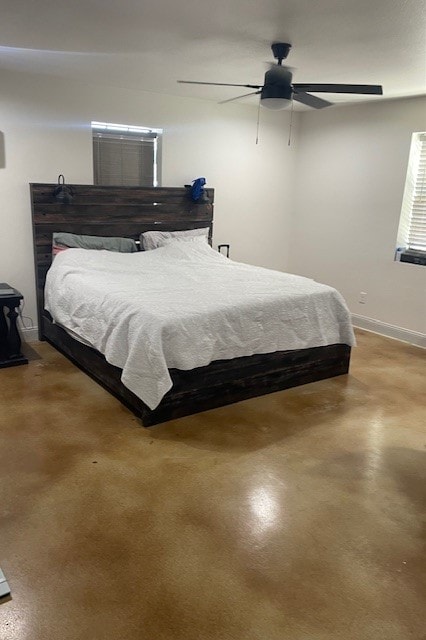 bedroom with ceiling fan and concrete floors