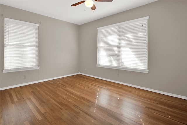 empty room featuring wood-type flooring and ceiling fan