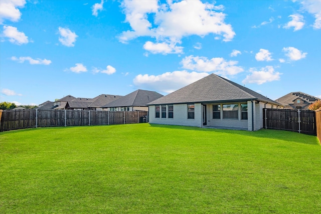 back of house with a lawn