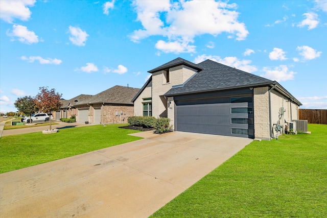 view of front of property with central AC, a front lawn, and a garage