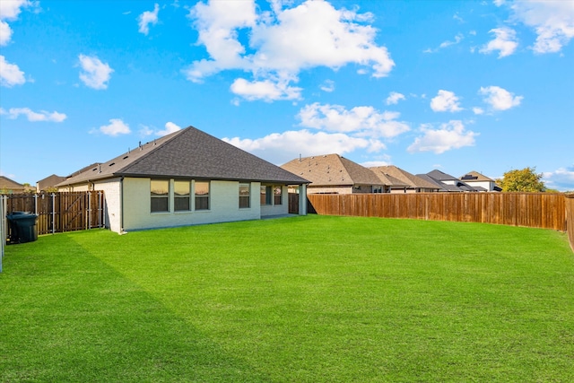 rear view of property with a yard