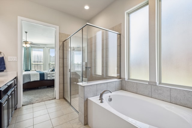 bathroom with ceiling fan, tile patterned flooring, vanity, and plus walk in shower