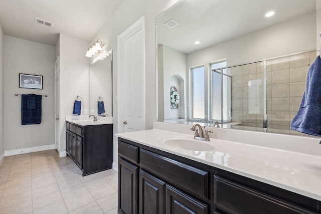 bathroom with vanity, tile patterned floors, and a shower with door