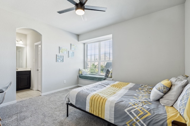 carpeted bedroom with connected bathroom and ceiling fan