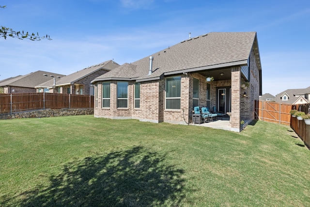 rear view of property with a lawn and a patio area