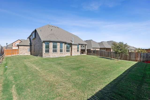 rear view of property featuring a yard