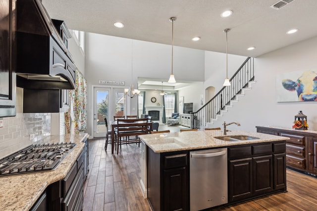 kitchen with dark wood-type flooring, sink, decorative light fixtures, dark brown cabinetry, and stainless steel appliances