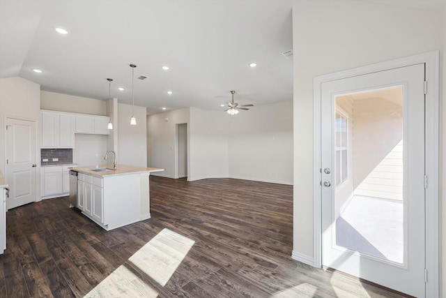 2511 Ridgecrest Ln, Sherman, TX 75092 - kitchen with a sink, dark wood-style floors, white cabinetry, a center island with sink, and backsplash