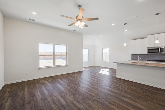2511 Ridgecrest Ln, Sherman, TX 75092 - unfurnished living room featuring dark wood-type flooring, a ceiling fan, baseboards, a sink, and recessed lighting