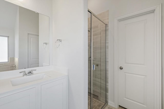 bathroom featuring a stall shower and vanity