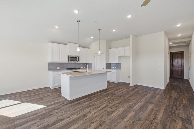 kitchen featuring white cabinetry, stainless steel appliances, and dark wood-type flooring