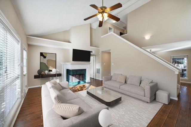 living room featuring dark hardwood / wood-style floors, high vaulted ceiling, and a wealth of natural light