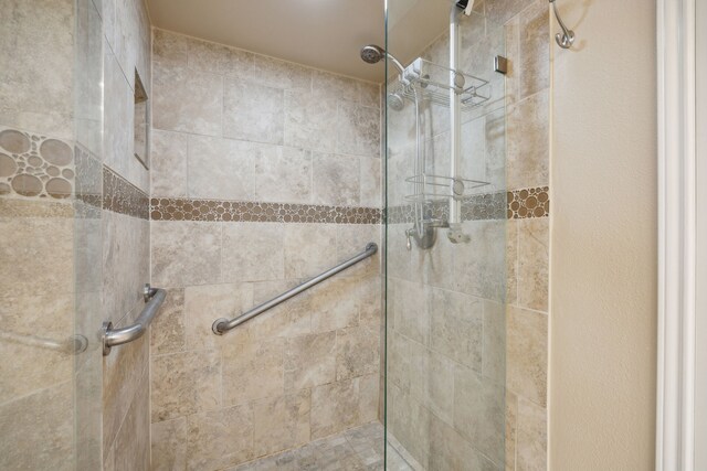 bathroom with a tile shower