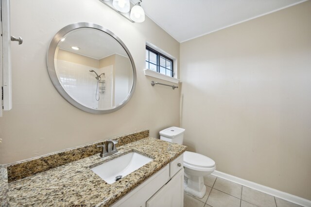 bathroom with a shower, tile patterned flooring, vanity, and toilet