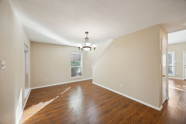 interior space with dark hardwood / wood-style flooring and a notable chandelier