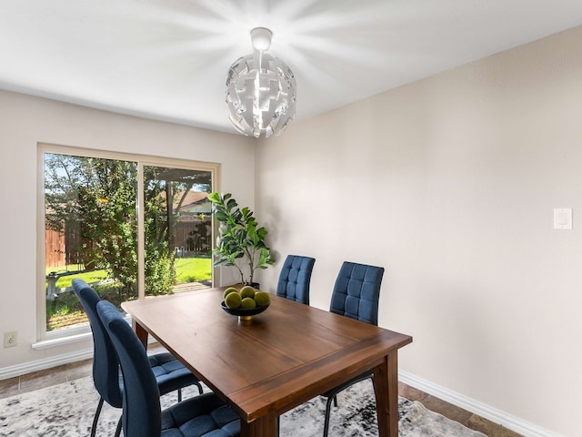 dining area featuring a wealth of natural light and a notable chandelier