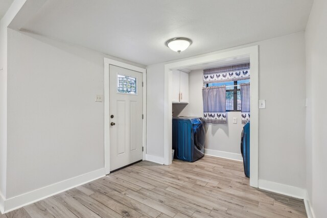 entryway featuring washer and dryer and light wood-type flooring