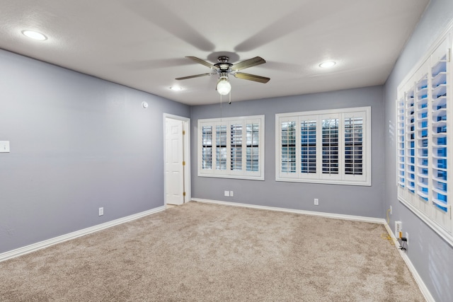 empty room with ceiling fan and carpet