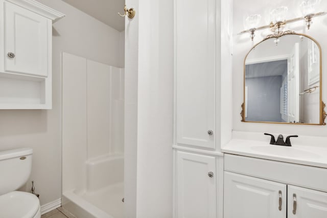 bathroom featuring vanity, toilet, and walk in shower