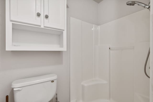 bathroom with toilet and walk in shower