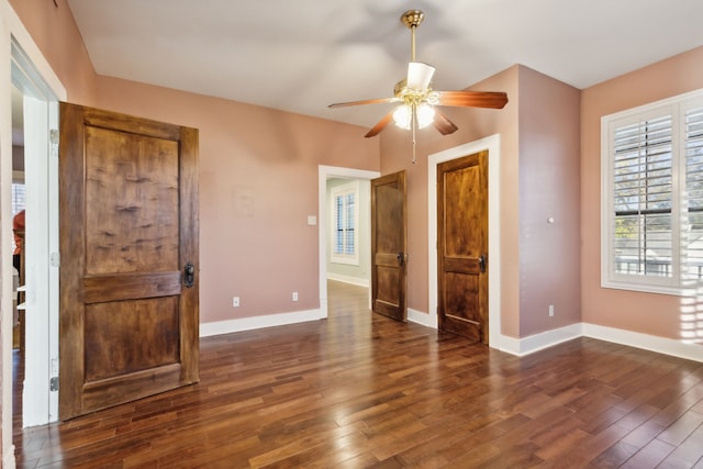 unfurnished room featuring ceiling fan and dark hardwood / wood-style flooring