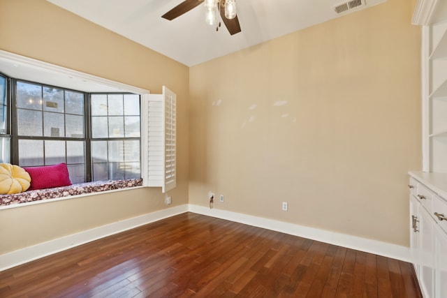 unfurnished room with dark hardwood / wood-style floors and ceiling fan