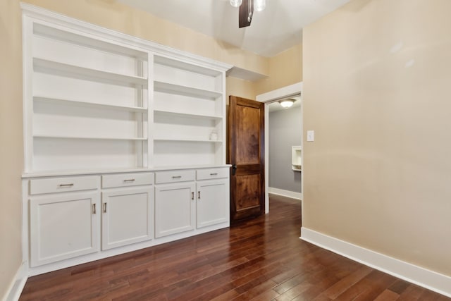 interior space with ceiling fan and dark wood-type flooring