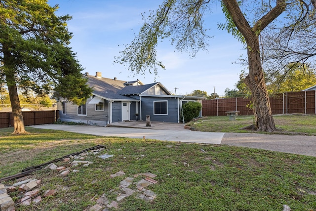 rear view of property featuring a yard and a patio