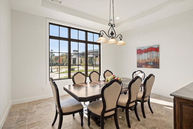 kitchen featuring dark brown cabinetry, a raised ceiling, wall oven, and backsplash