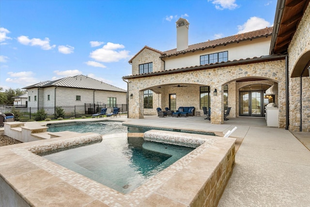 back of property featuring a patio area, an outdoor hangout area, a swimming pool with hot tub, and ceiling fan