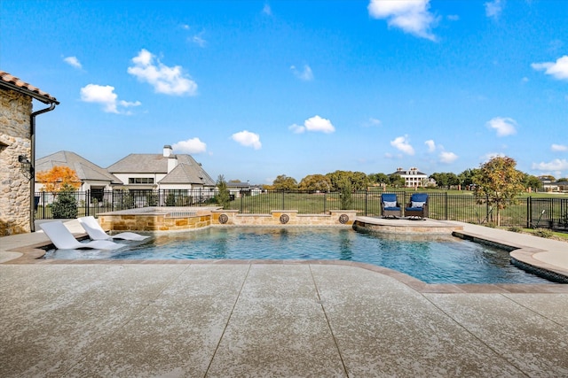 view of pool featuring pool water feature and a patio area