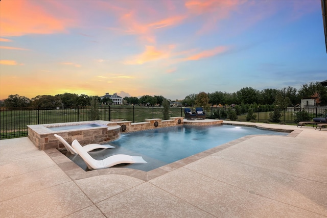 view of pool with an in ground hot tub, pool water feature, and a patio