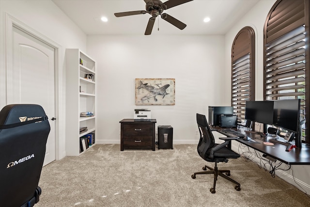 carpeted living room with a towering ceiling and a stone fireplace