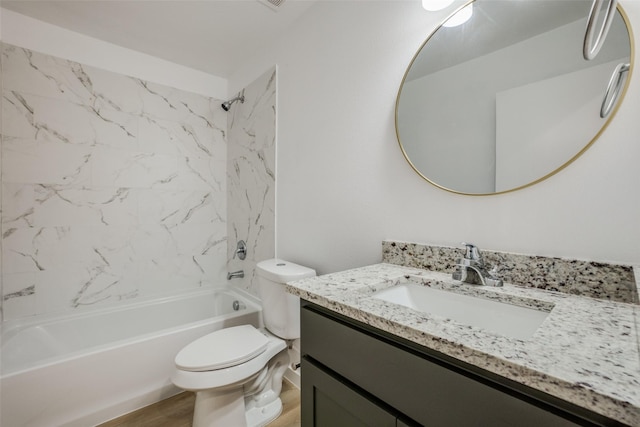 full bathroom with hardwood / wood-style floors, vanity, toilet, and tiled shower / bath